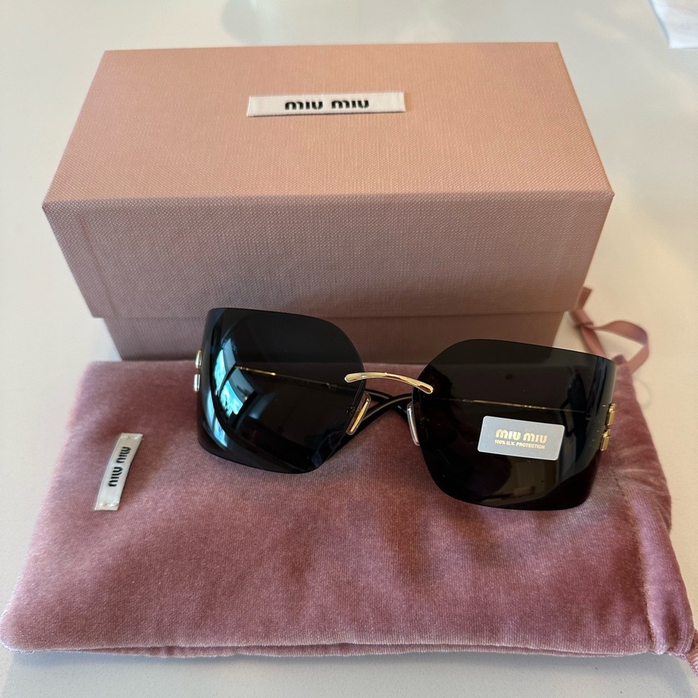 Miu Miu Mu 54YS sunglasses in dark grey with gold detailing